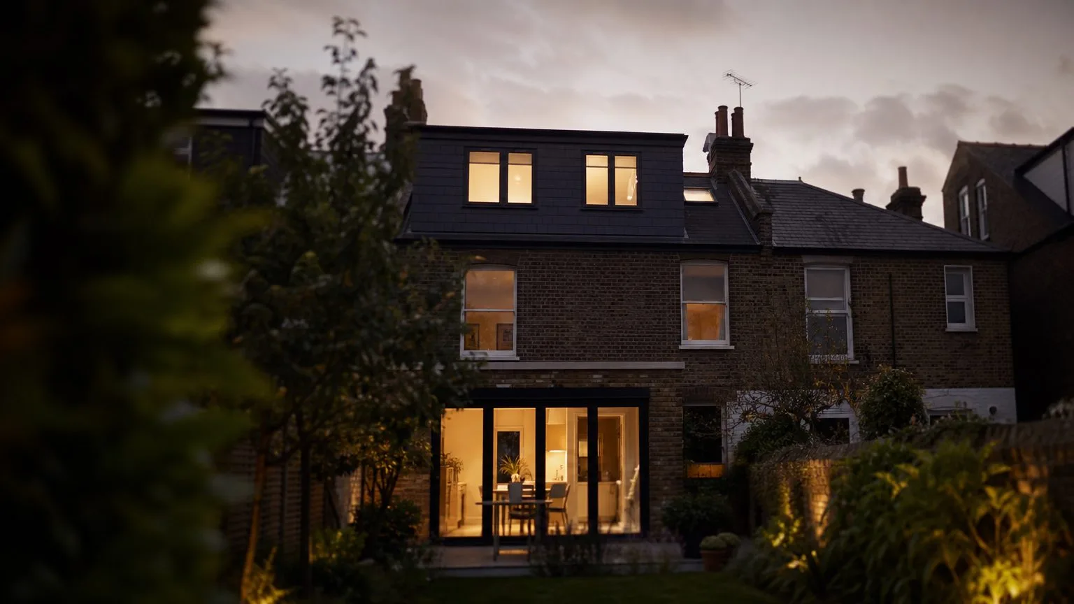 Completed brick home and loft conversion in evening light